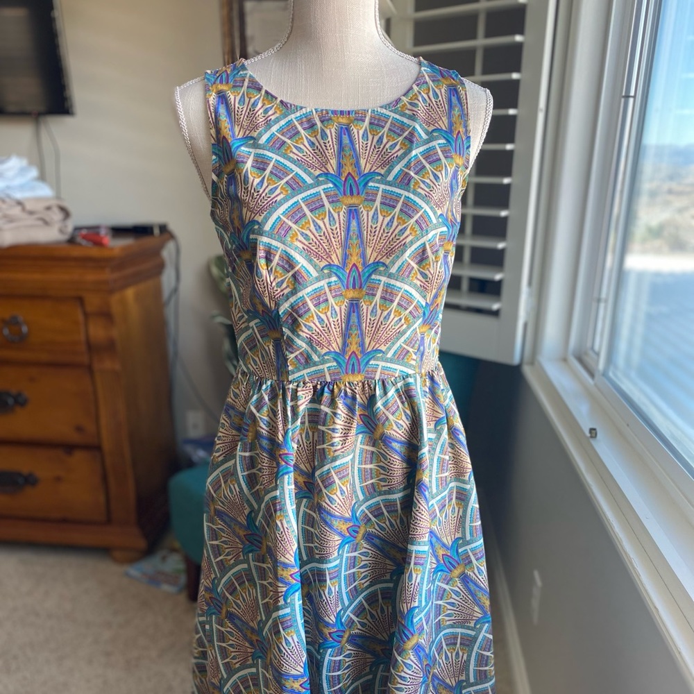 Cutest dress with peacock like print POCKETS!!